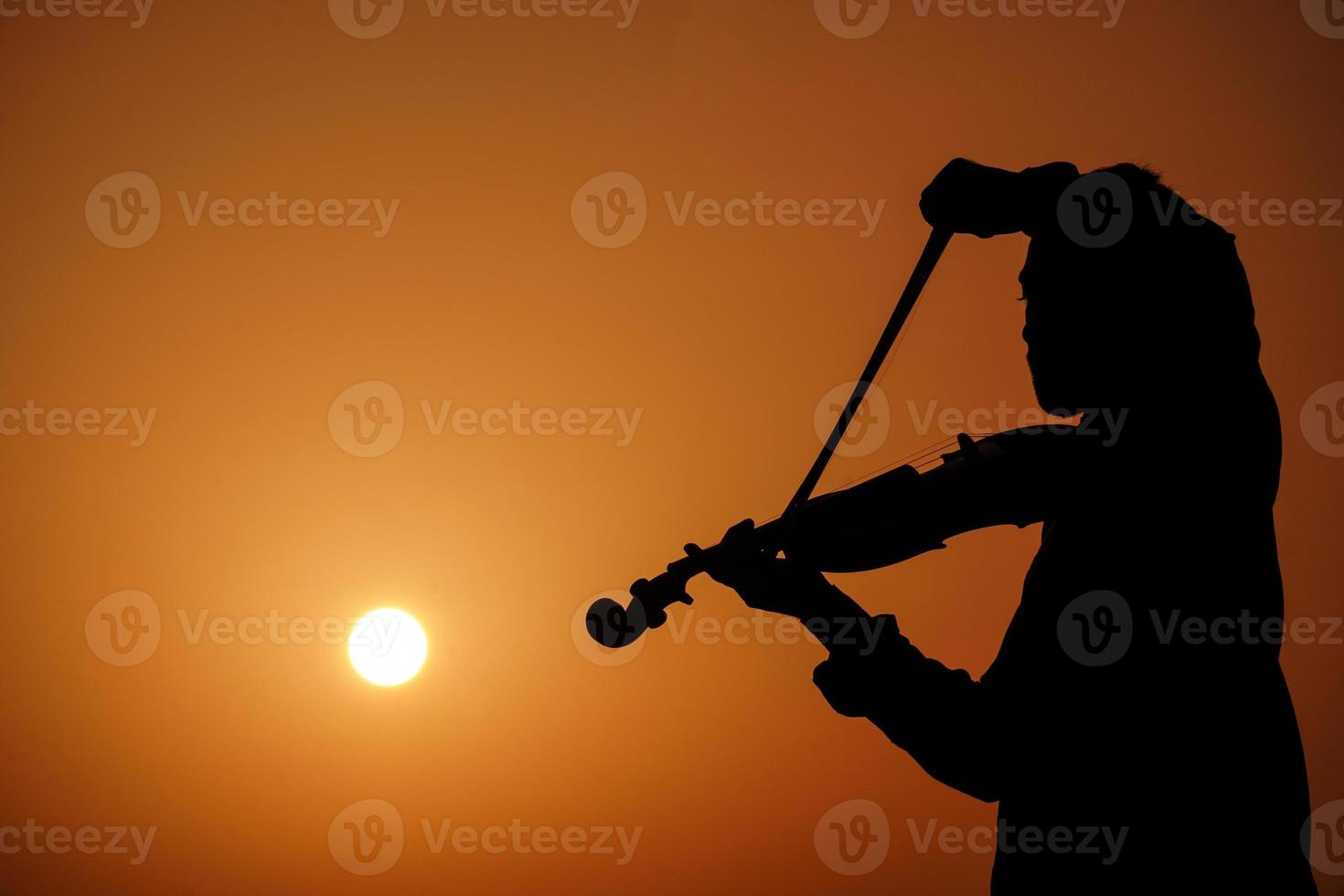 musician playing violin. Music and musical tone concept. silhouette images of man musician photo