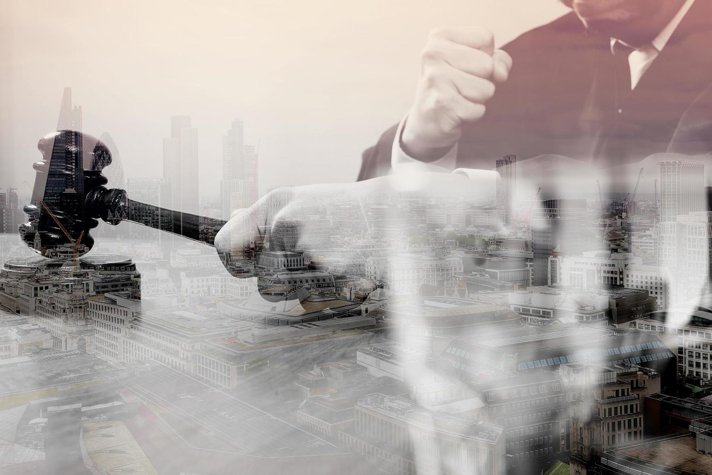 double exposure of justice and law concept.Male judge in a courtroom with the gavel,working with smart phone,digital tablet computer docking keyboard on wood table,London architecture city photo