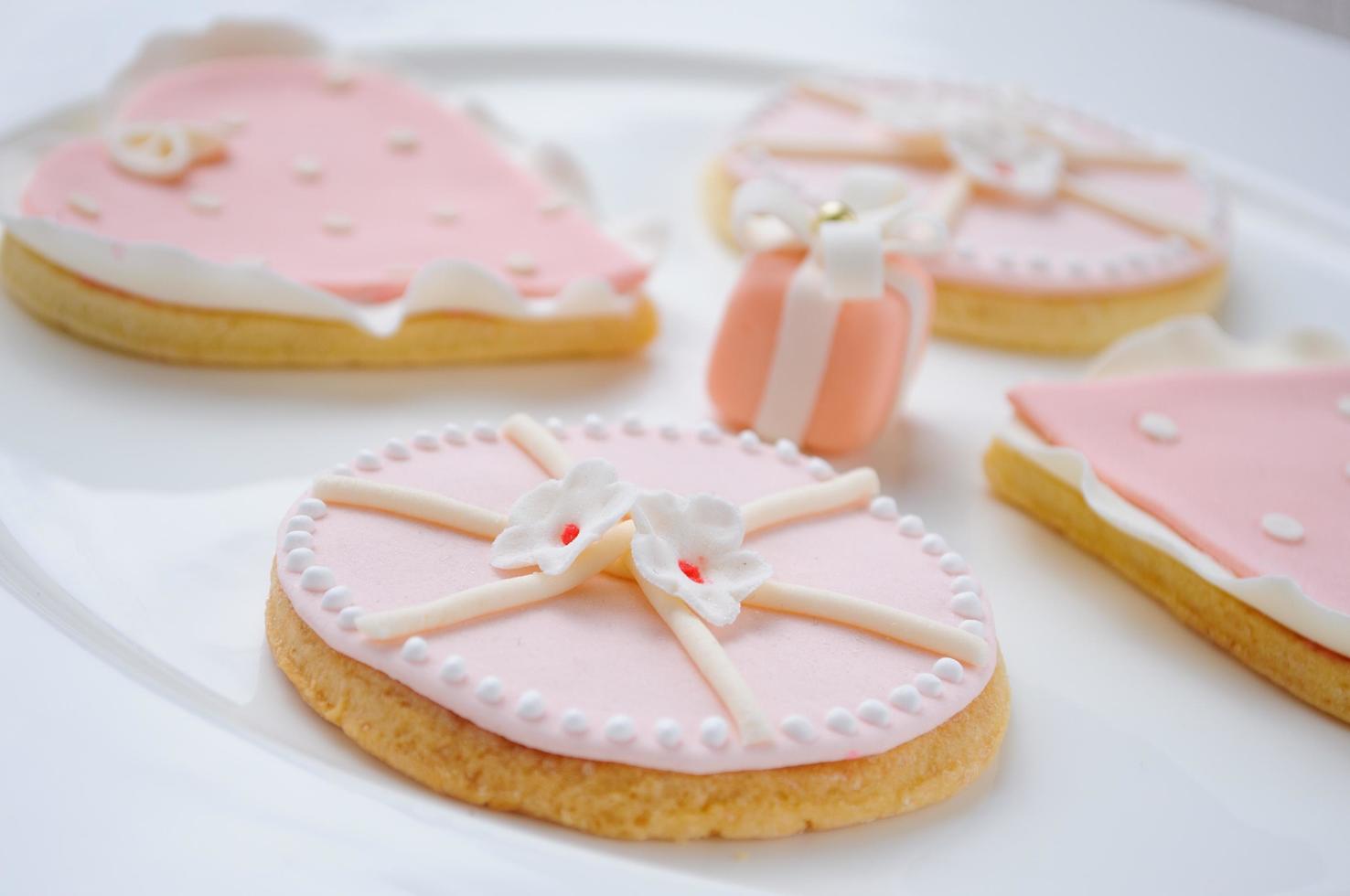 many pink cookies on a white plate photo