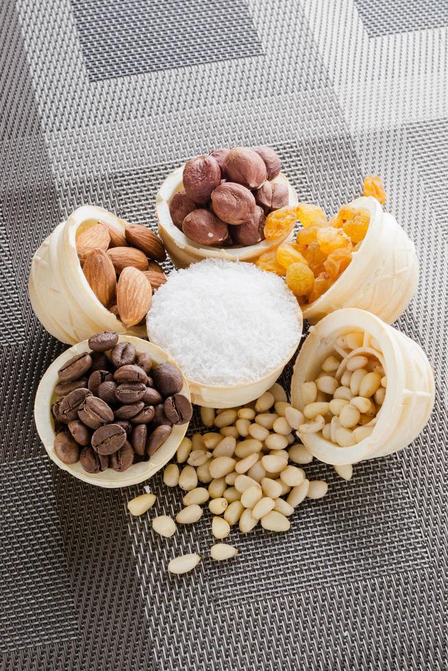 waffle basket with coffee beans, coconut, raisins, almonds, peanuts, hazelnuts and pine nuts photo