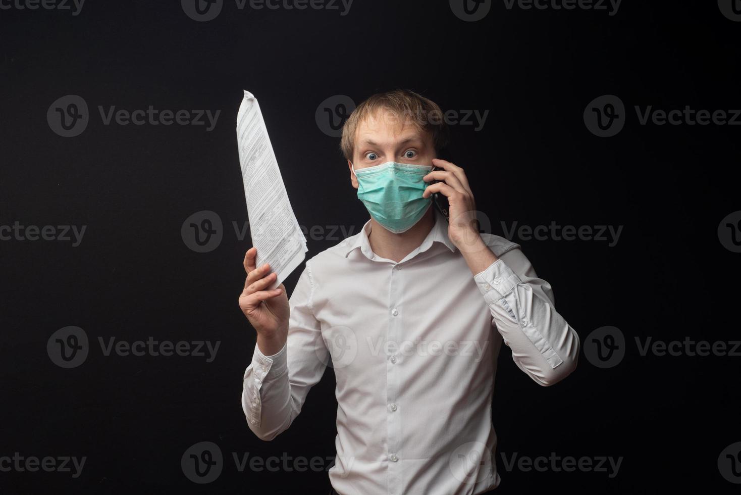 A young doctor studies papers and quarrels over the phone due to poor results. photo
