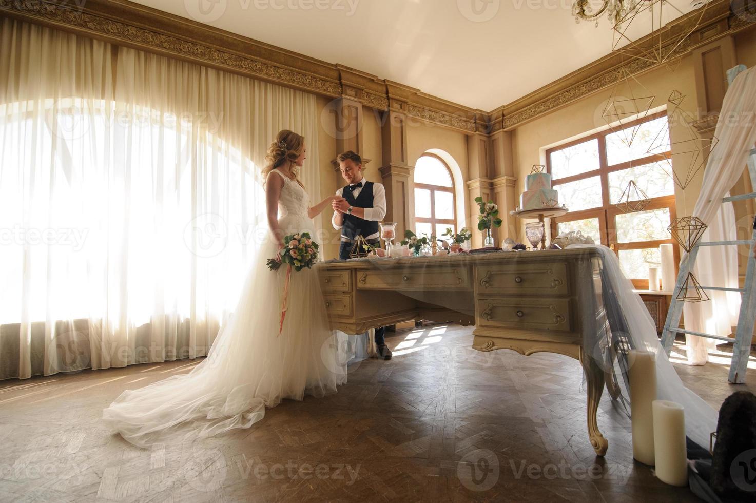 Groom puts a wedding ring on his bride. photo