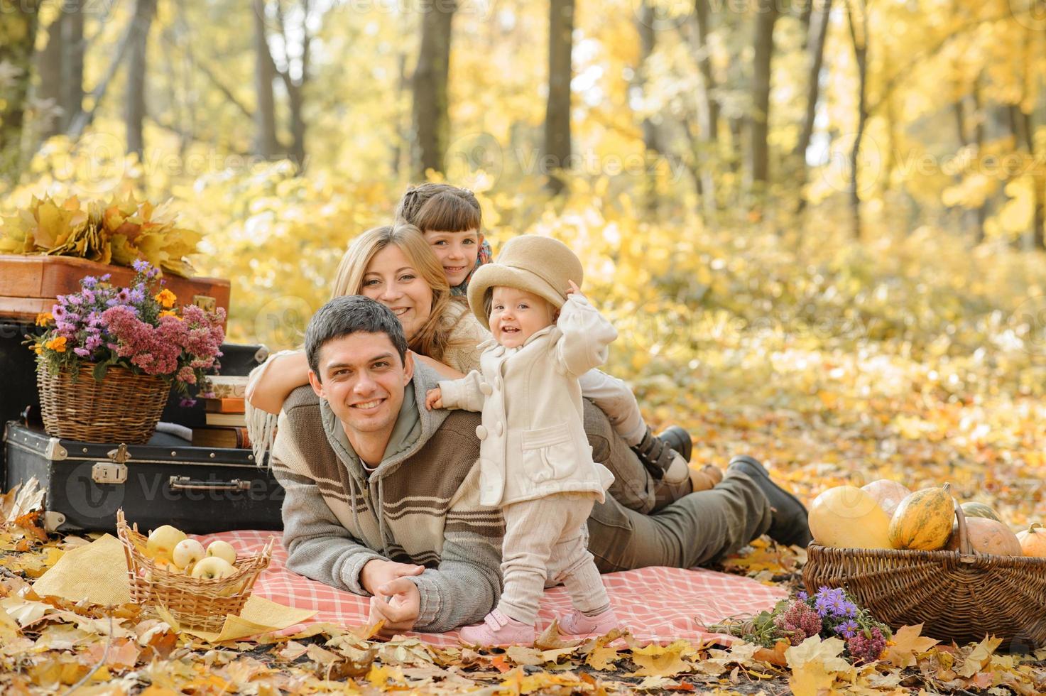 A family with two daughters went on a picnic. Autumn time. photo