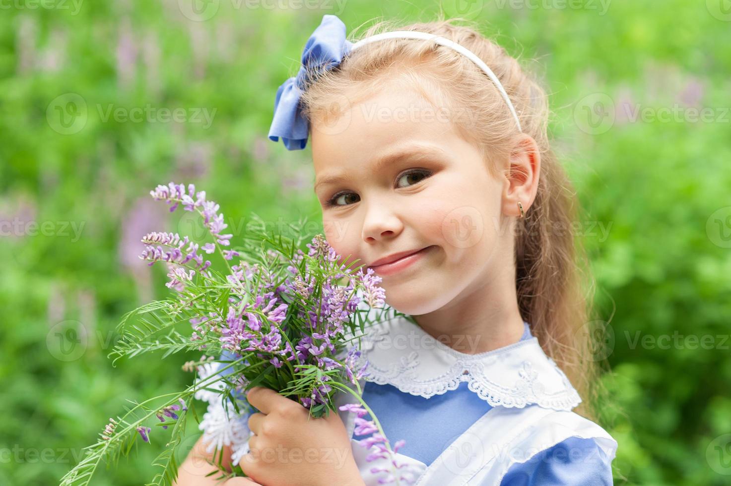 Portrait of a little cute girl dressed as Alice. Stylized photo shoot in nature.