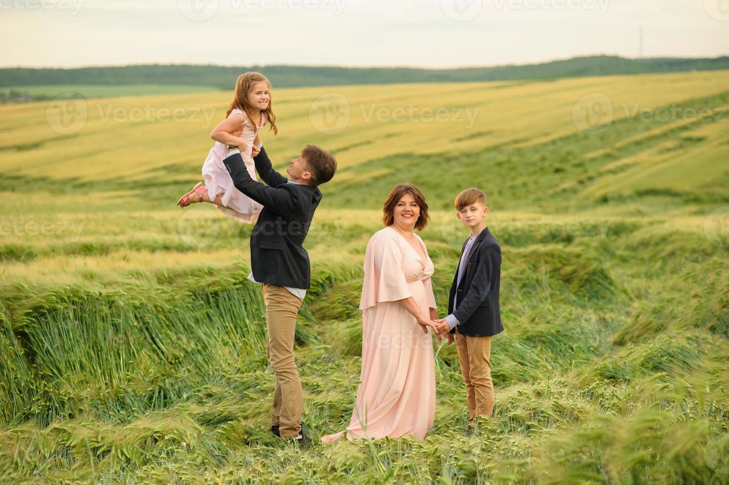 Happy family in the field photo