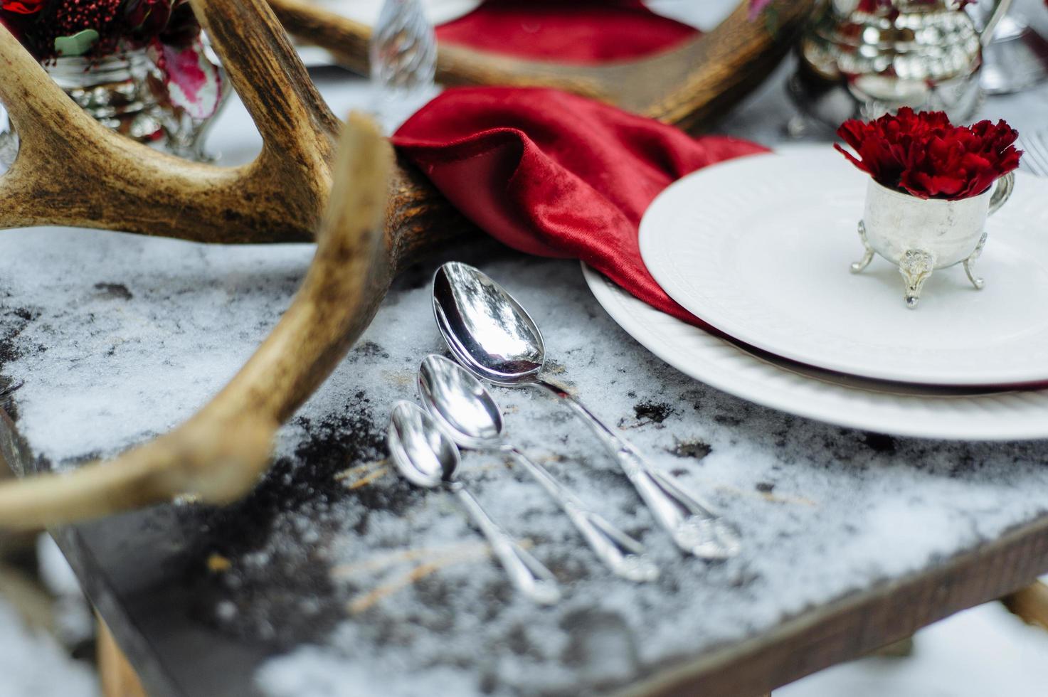 Set on a snowy table spoons photo