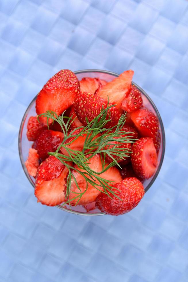 Fresh strawberries on blue tablecloth photo
