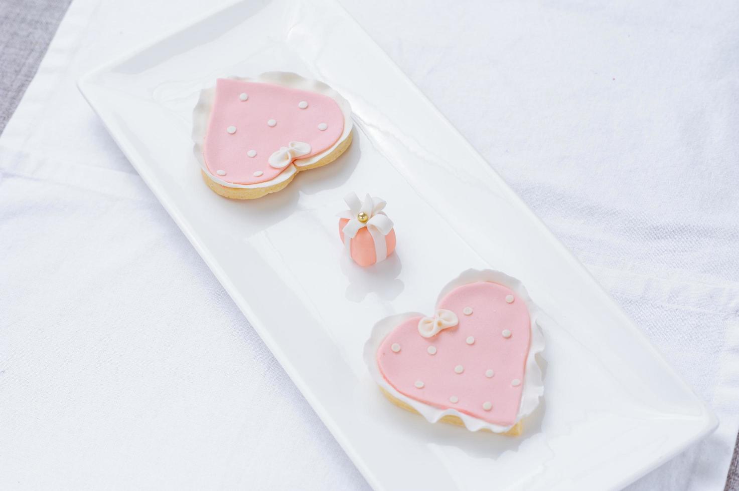 many pink cookies on a white plate photo