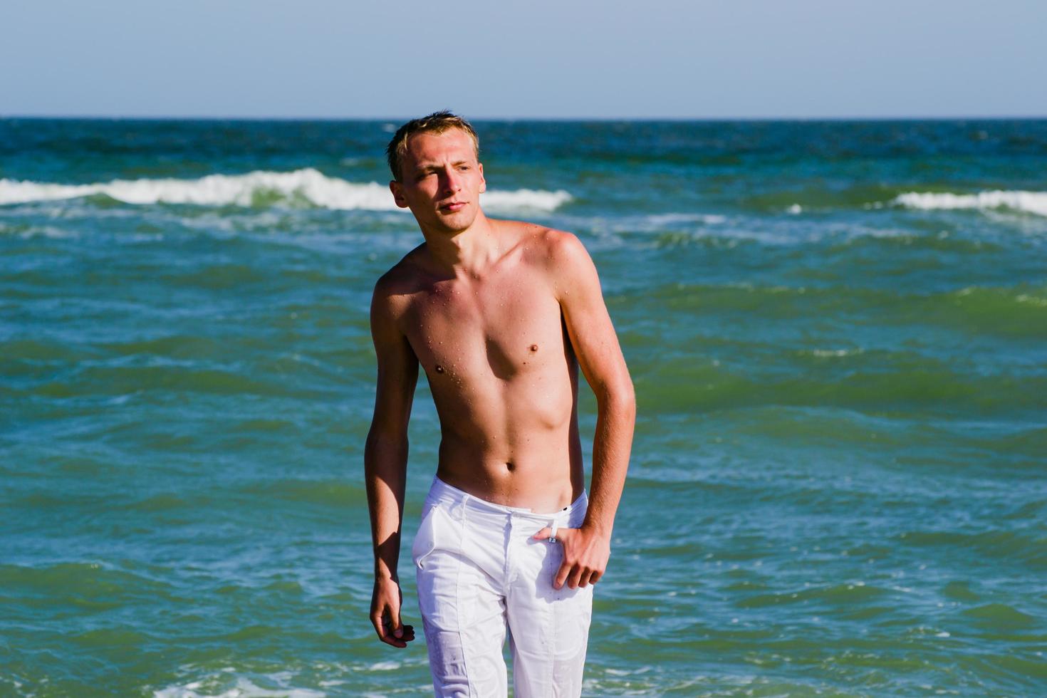 a man walking along the seashore photo