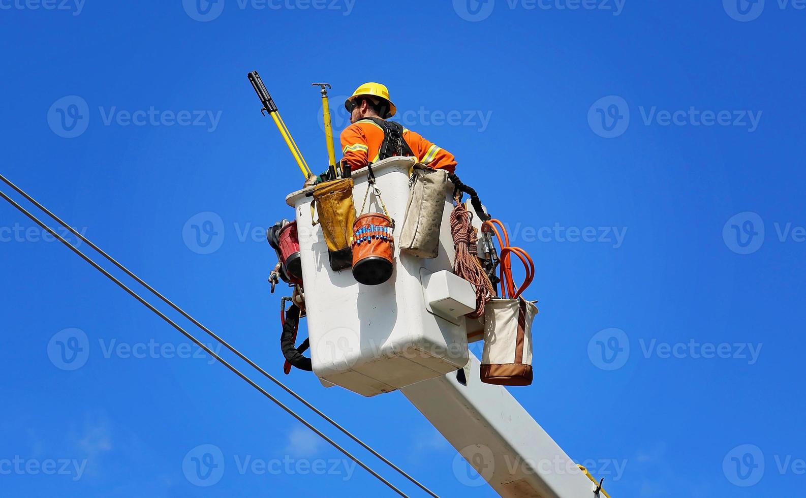 Electrician fixing electric lines photo