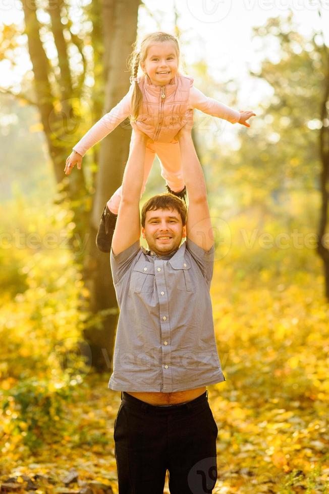 family walking in autumn park photo