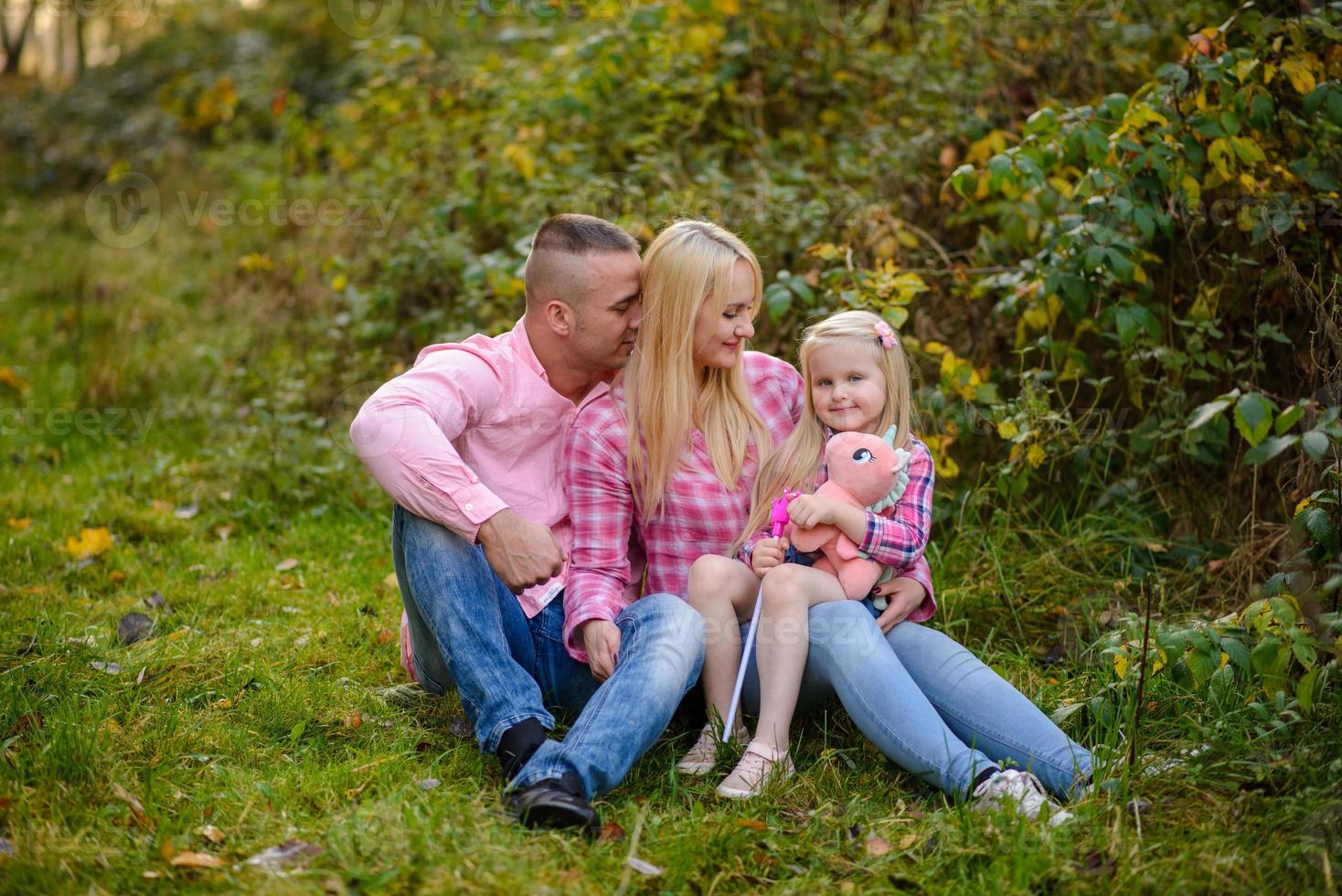 Father, daughter and mother walking outdoors. Happy family. photo