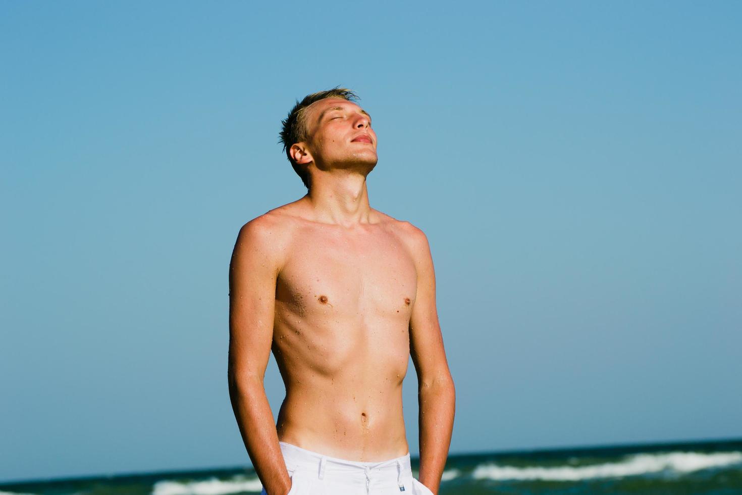 a man walking along the seashore photo