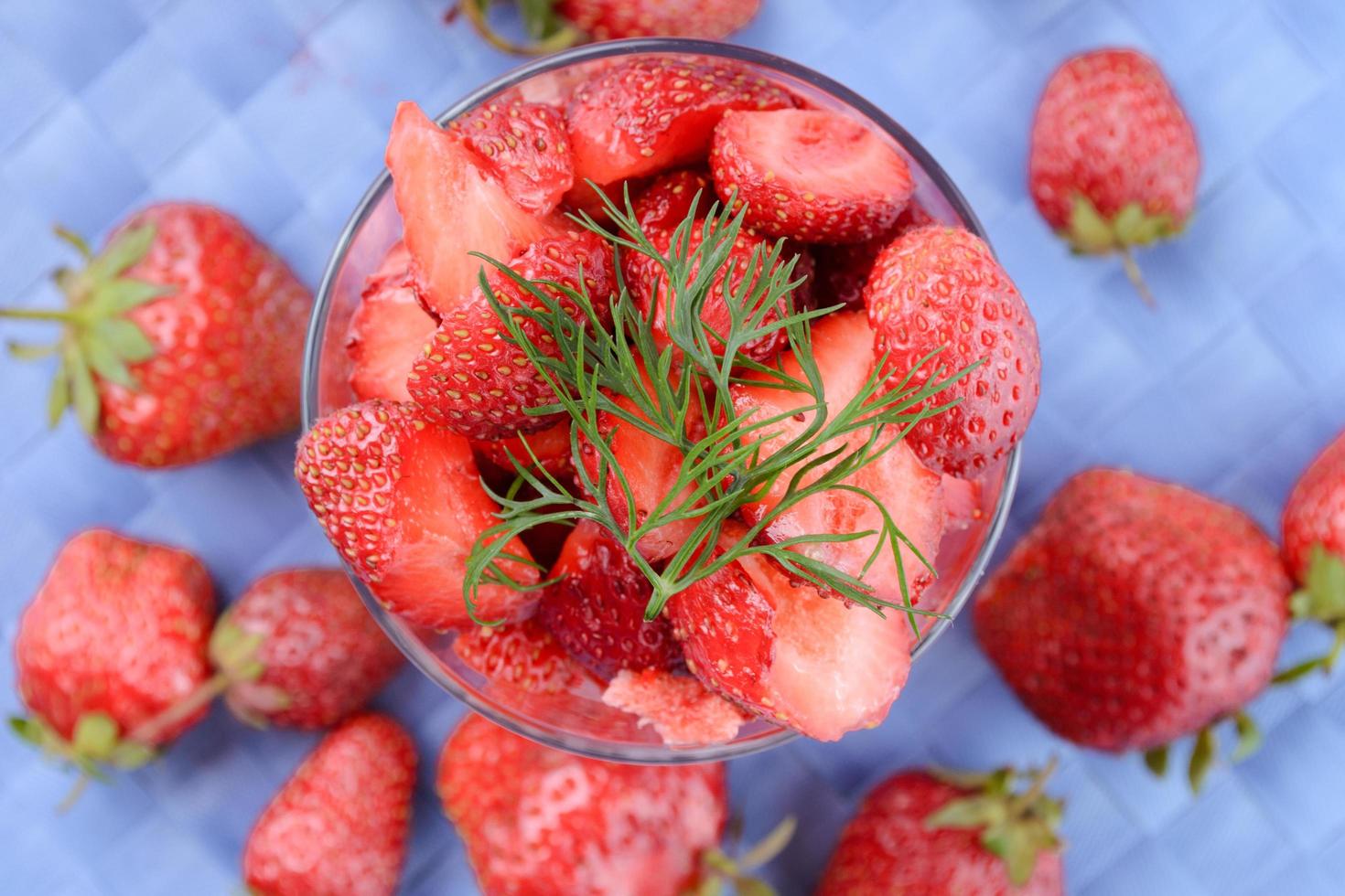 Fresh strawberries on blue tablecloth photo