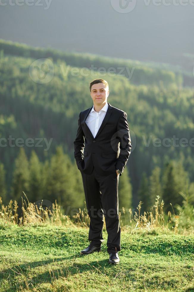 Wedding photography in the mountains. The bride and groom hug tightly. photo