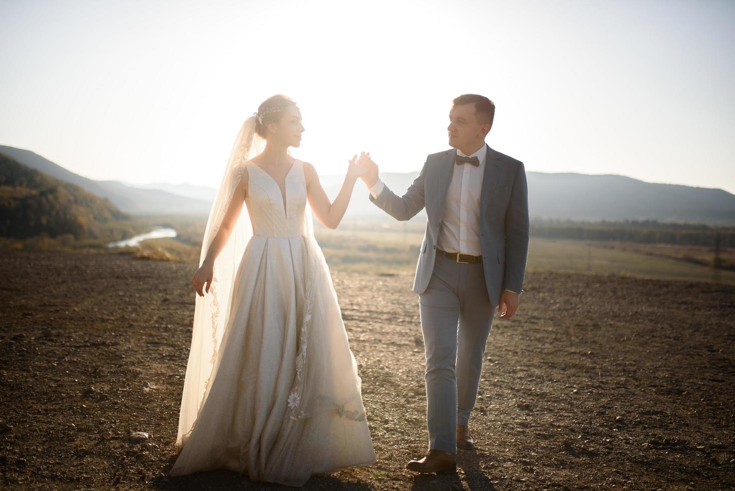 Wedding photo session of the bride and groom in the mountains. Photoshoot at sunset.