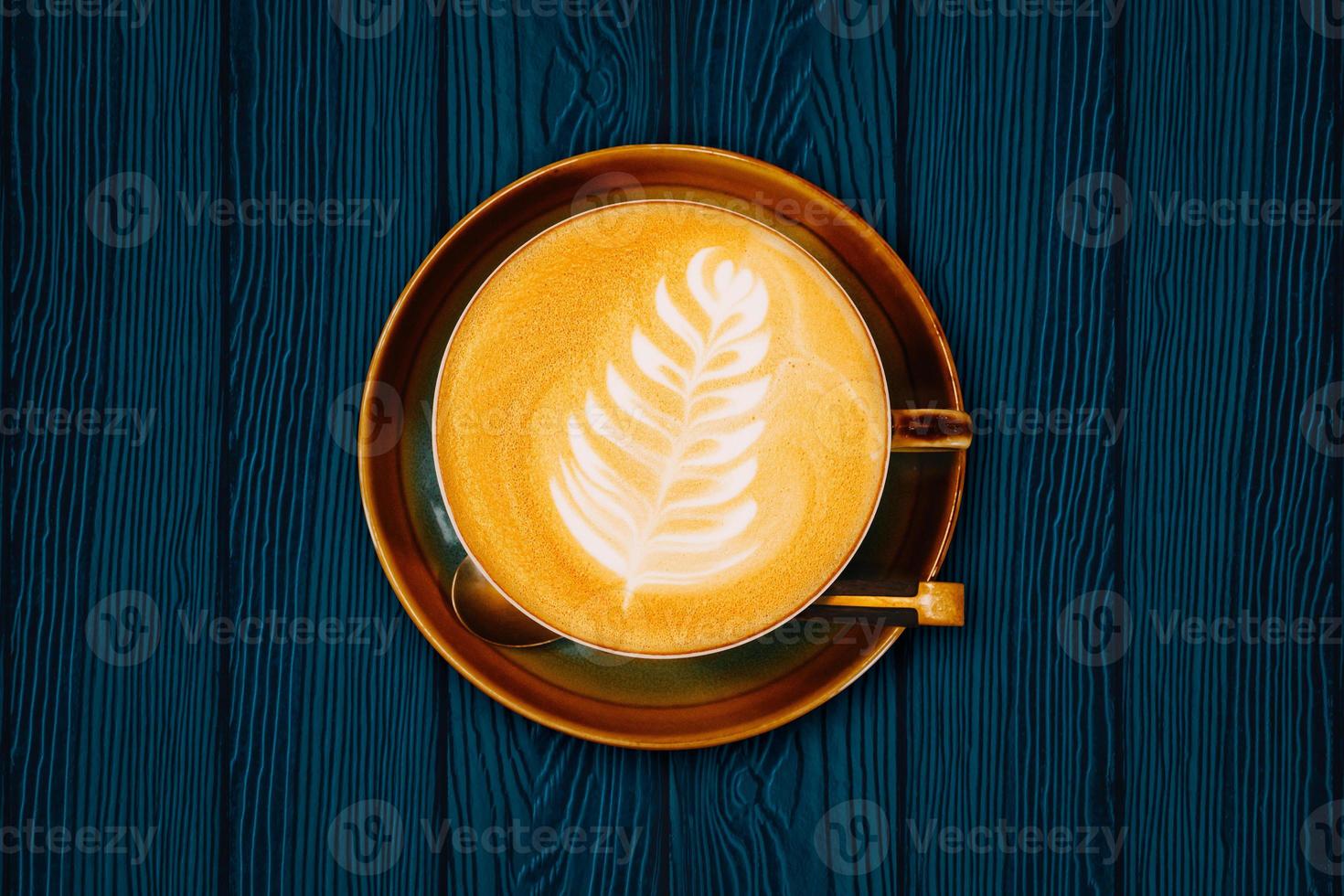 Top view of hot coffee cup on wood table background. photo