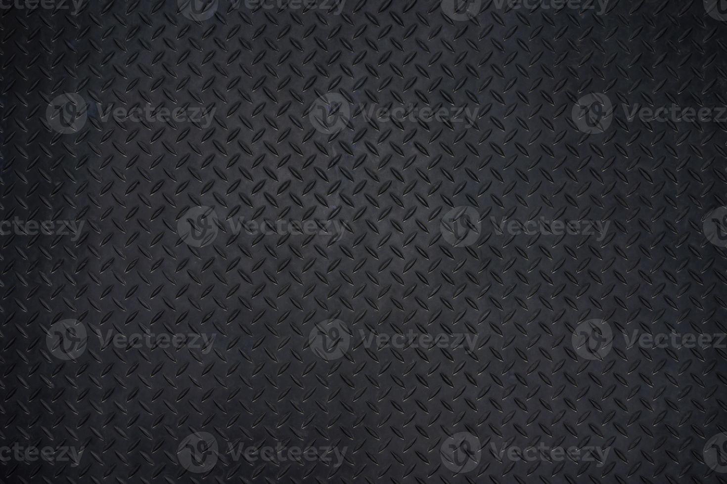 Close-up photos of Black metal floor plate texture details background. Dark wall and copy space.