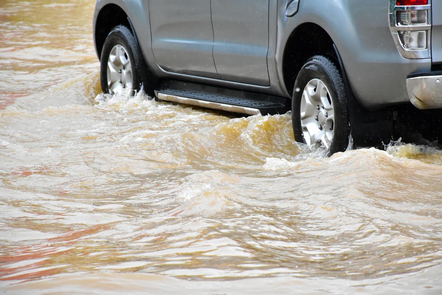 Pickup car and vehicle in floodwater, car insurance and dangerous situation concept. photo