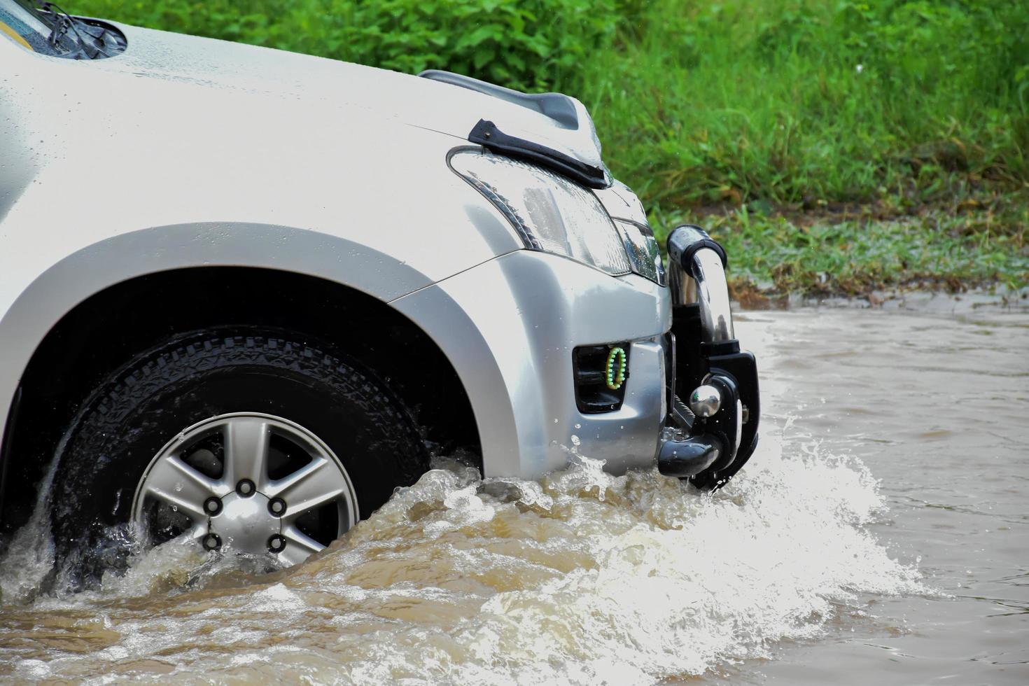 Pickup car and vehicle in floodwater, car insurance and dangerous situation concept. photo