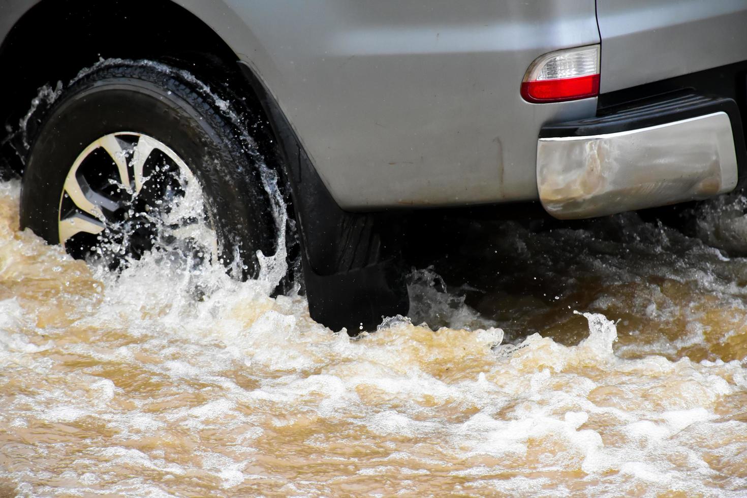 Pickup car and vehicle in floodwater, car insurance and dangerous situation concept. photo