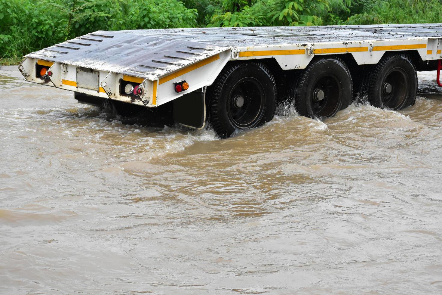 Pickup car and vehicle in floodwater, car insurance and dangerous situation concept. photo