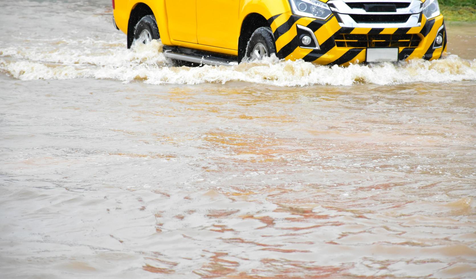 Pickup car and vehicle in floodwater, car insurance and dangerous situation concept. photo