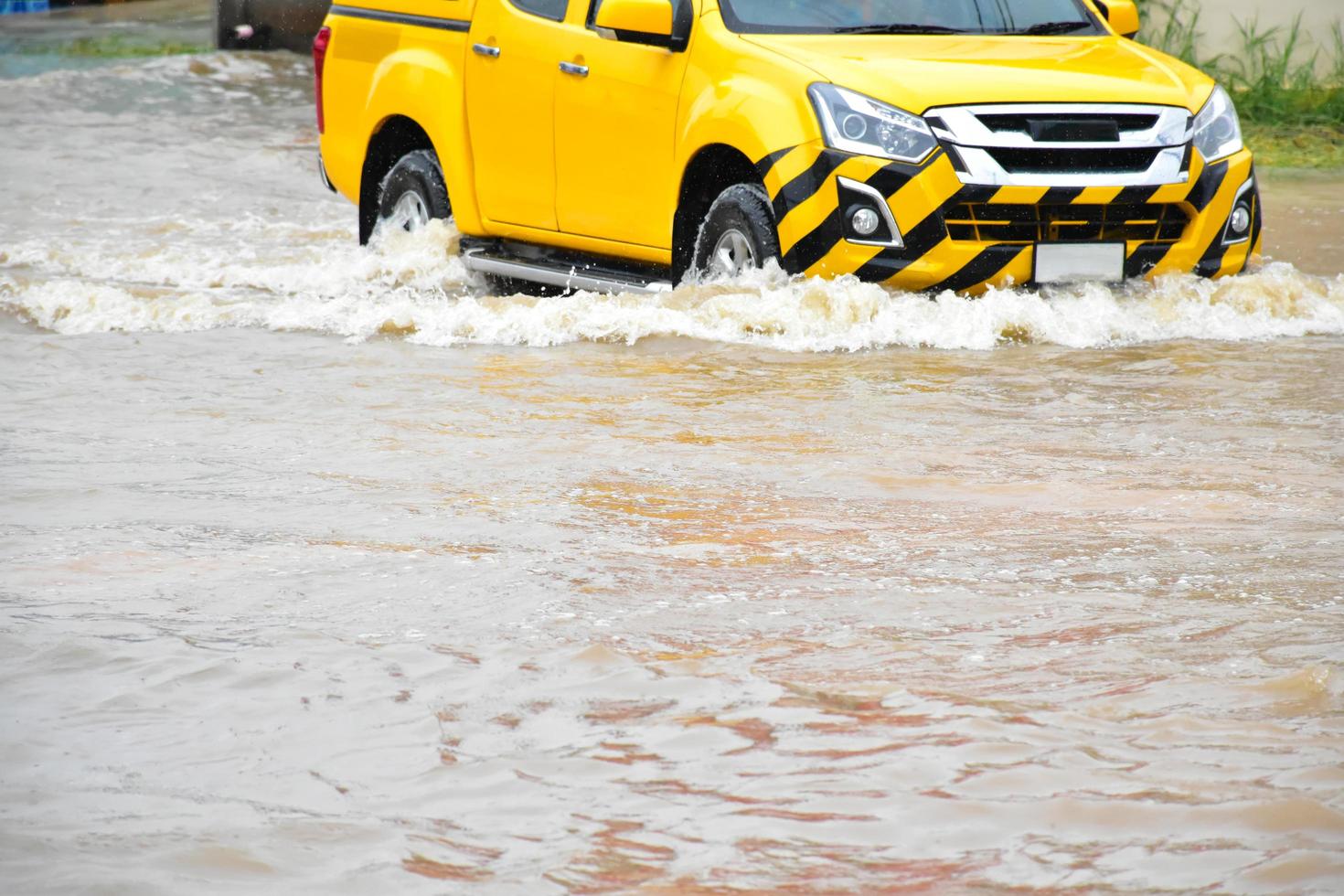 Pickup car and vehicle in floodwater, car insurance and dangerous situation concept. photo