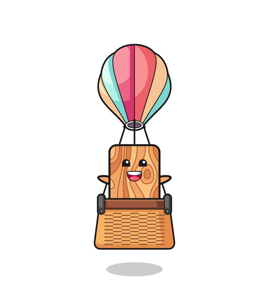 mascota de tablones de madera montando un globo aerostático vector