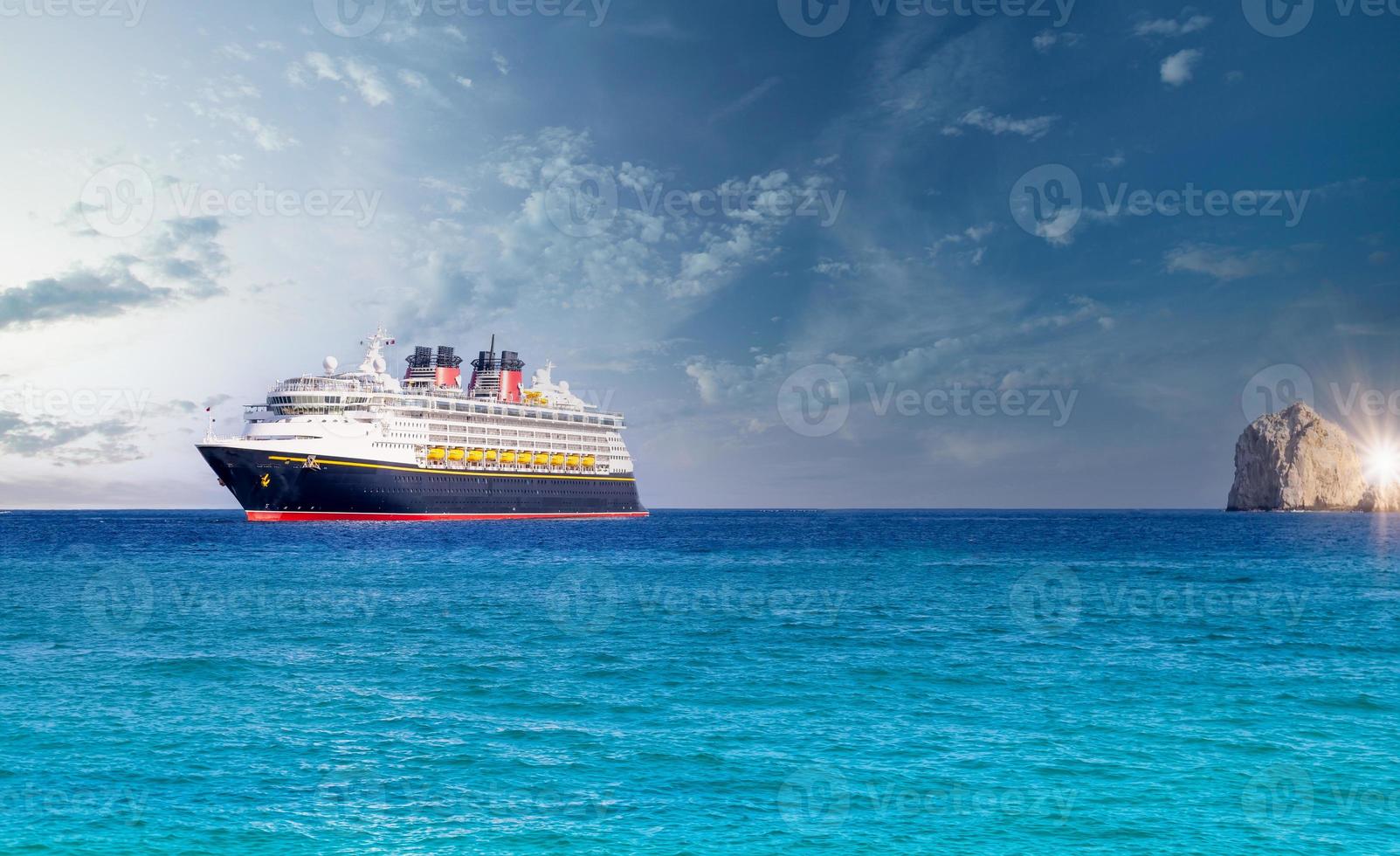 Mexico, Cabo San Lucas, Los Cabos, vacation cruise ship docked close to El Medano beach and scenic landmark tourist destination of Arch of Cabo San Lucas, EL Arco photo