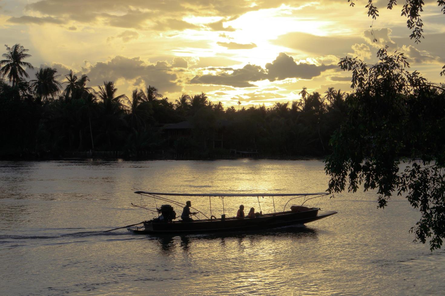 Fantastic twilight sky above Meaklong river with long tail boat. photo