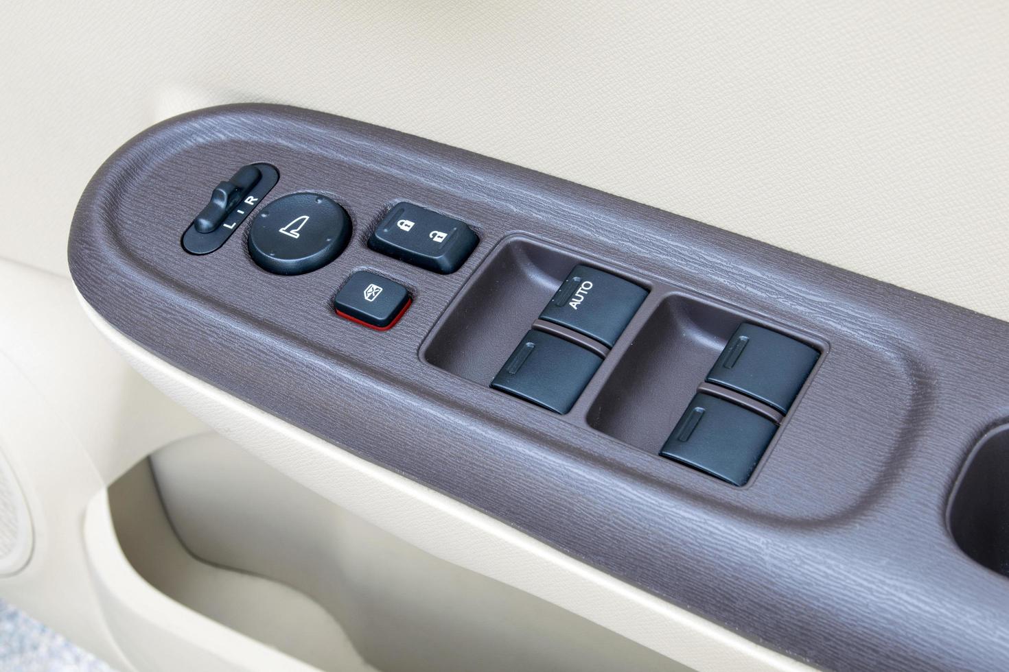 car interior details of door handle with windows controls and adjustments photo