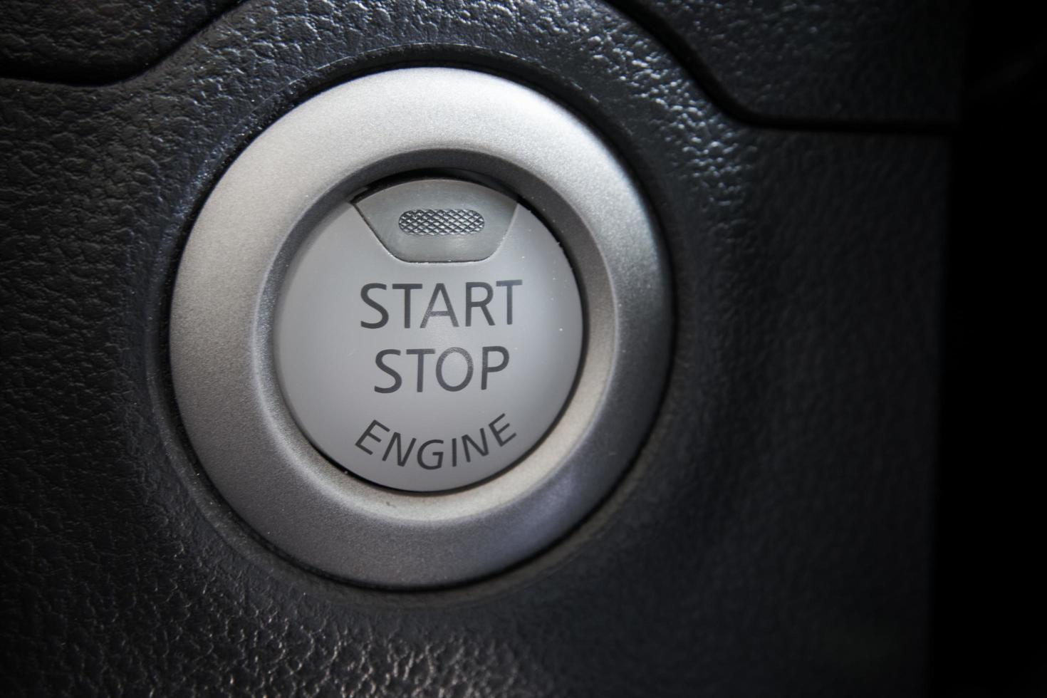 Engine start stop button from a modern car interior photo