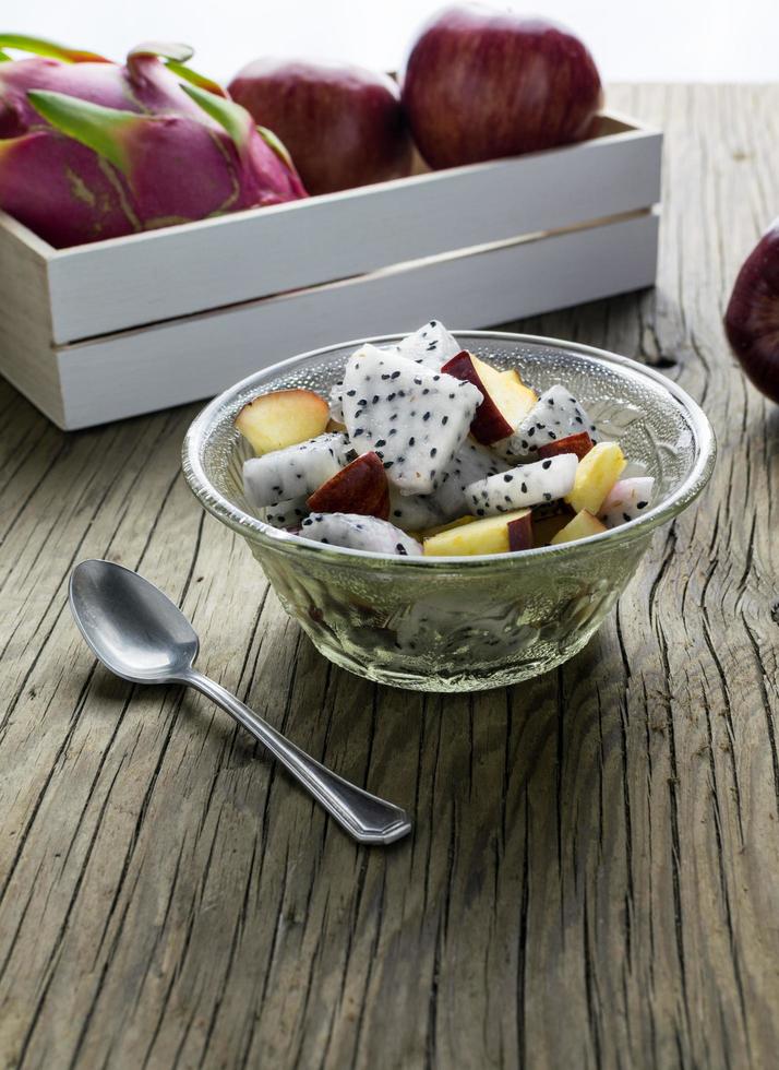 fruit salad in a bowl on the wooden table. Selective focus. photo