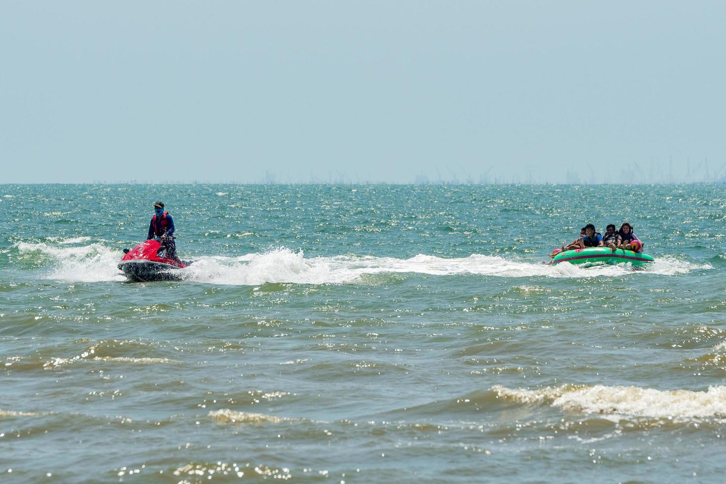 Chonburi, Thailand -06 Mar. 2021 The atmosphere of people playing water activities at Bangsaen beach. photo