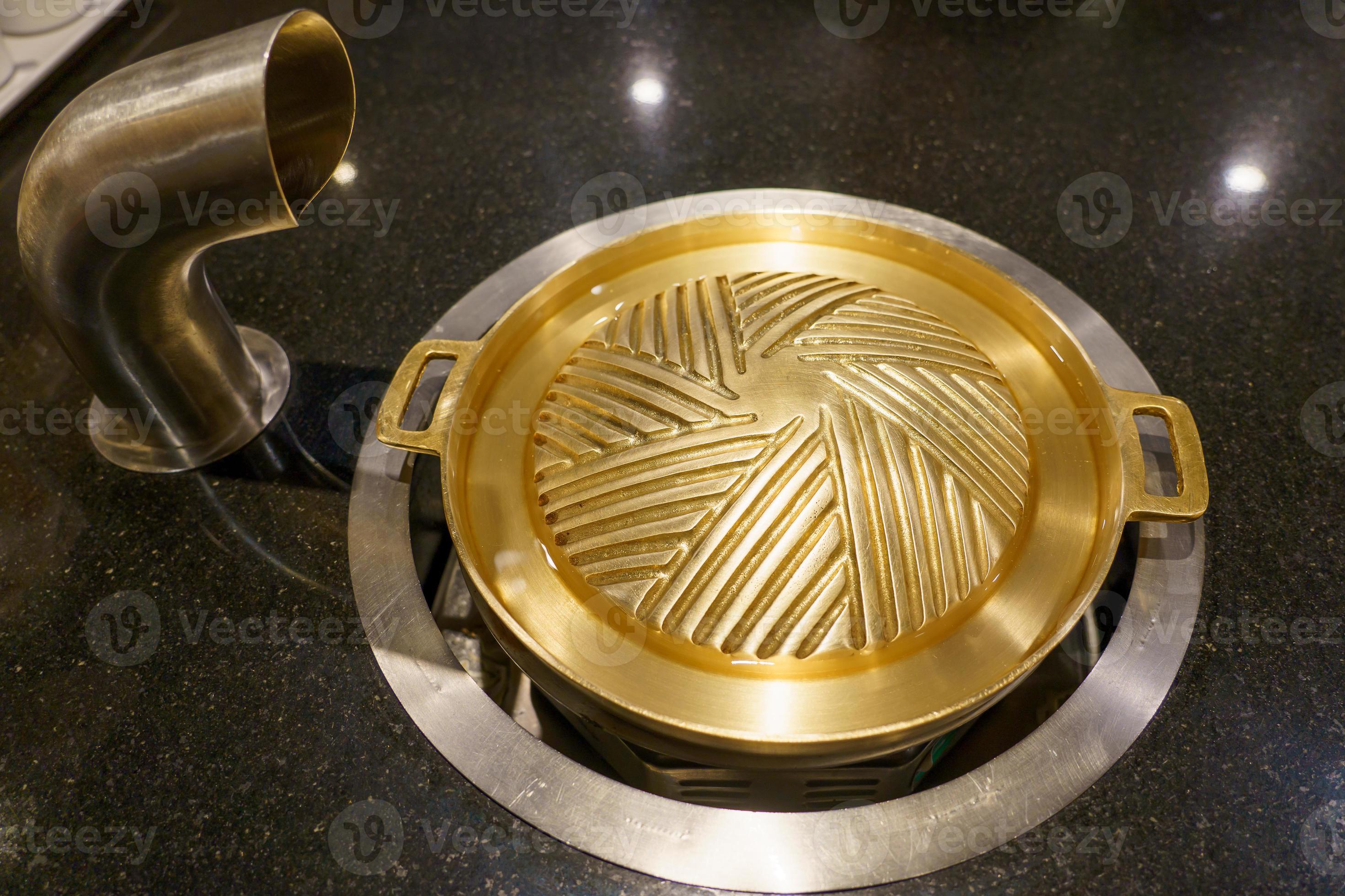 Brass grill pan placed on the gas stove 6929378 Stock Photo at