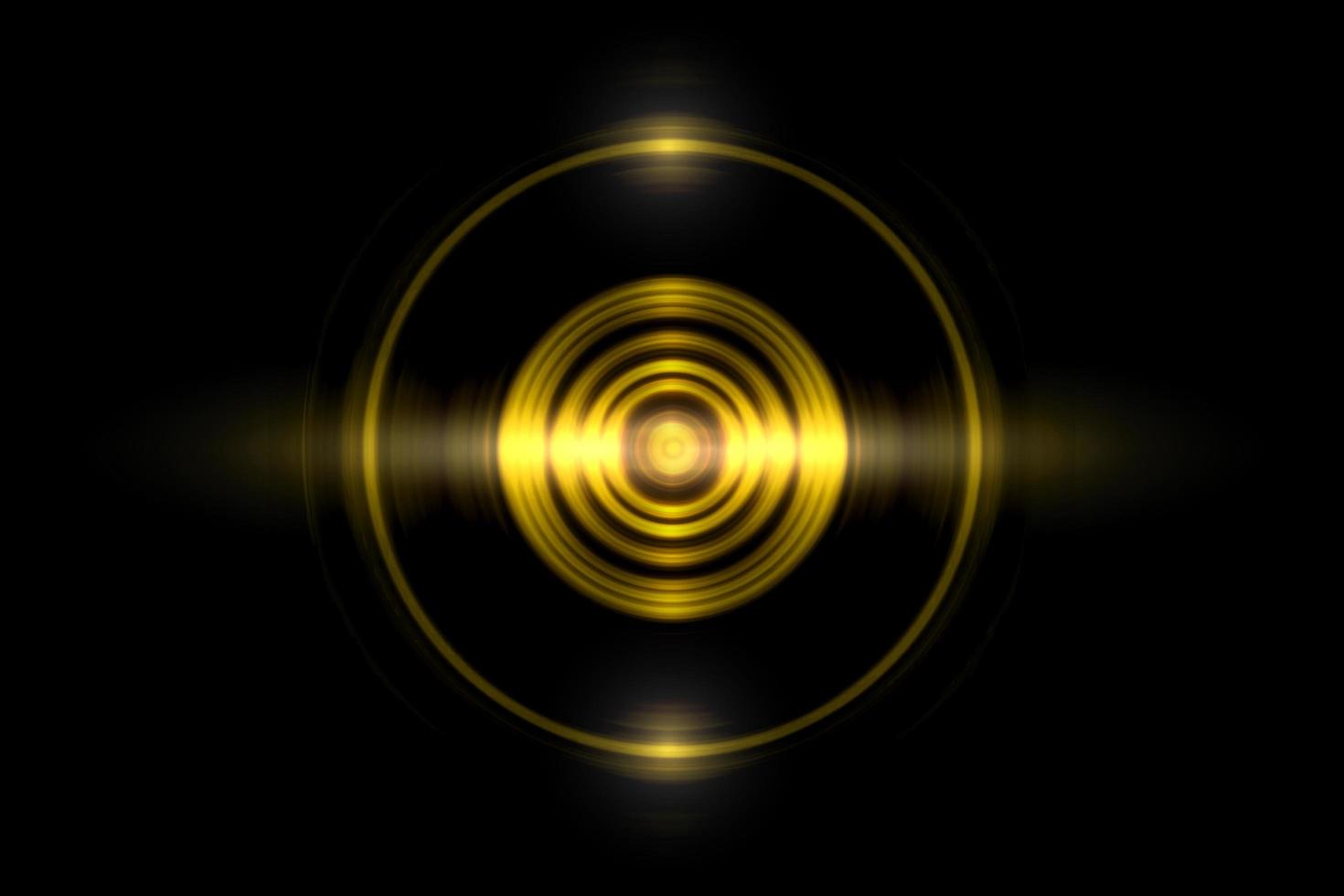 Abstract gold circle ring light effect with sound waves oscillating on black background photo
