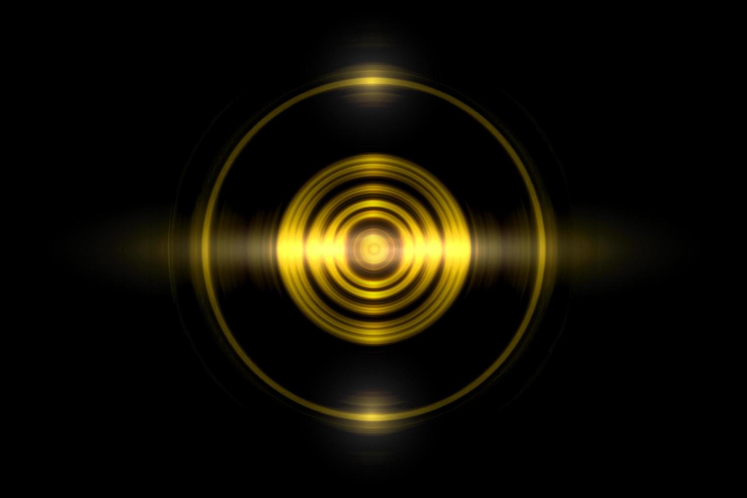 Abstract gold circle ring light effect with sound waves oscillating on black background photo