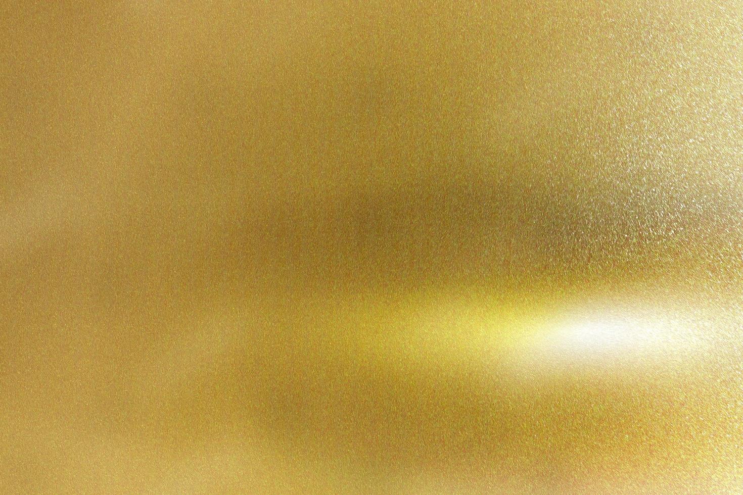 Light shining down on gold foil metal plate with copy space, abstract texture background photo