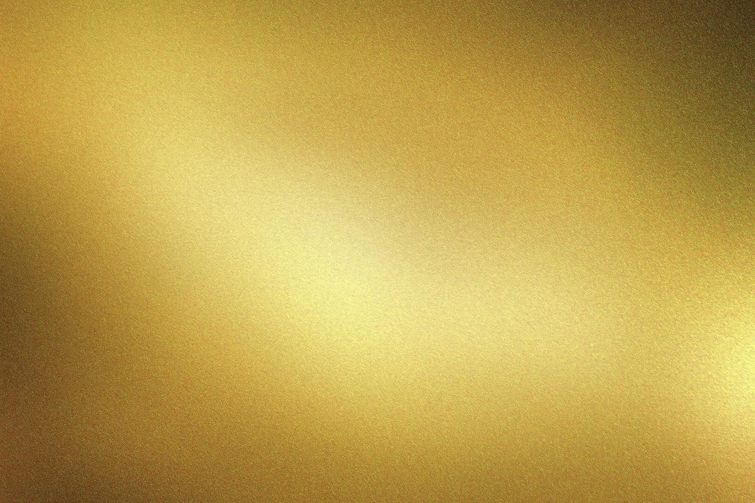 Glowing dark gold foil metal wall with copy space, abstract texture background photo