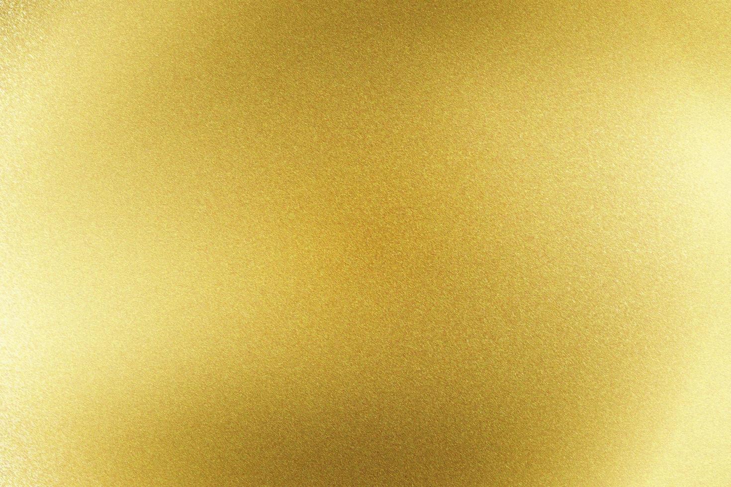 fondo de textura abstracta, luz que brilla en una hoja de acero inoxidable dorado foto