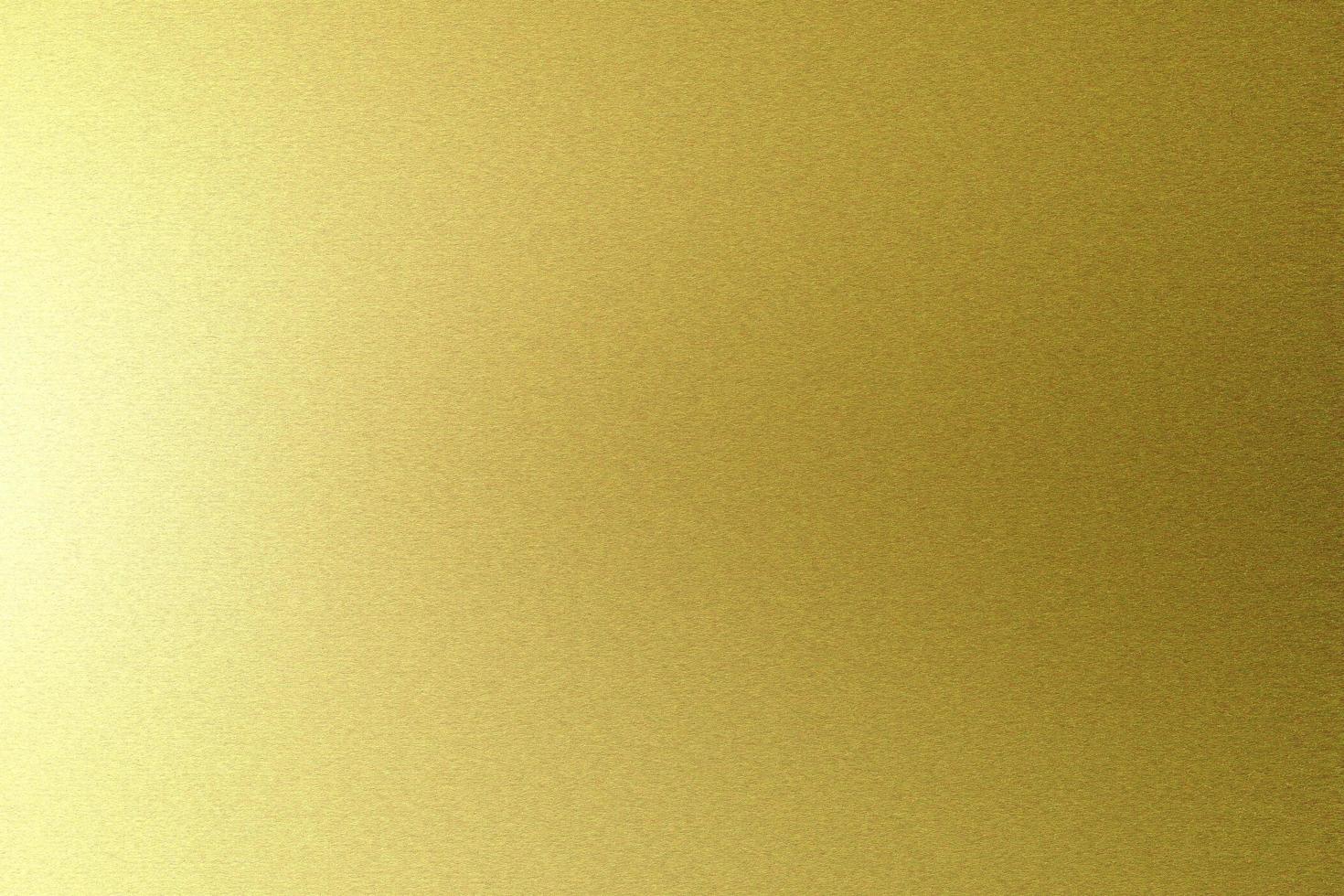 Brushed gold metallic wall with scratched surface, abstract texture background photo