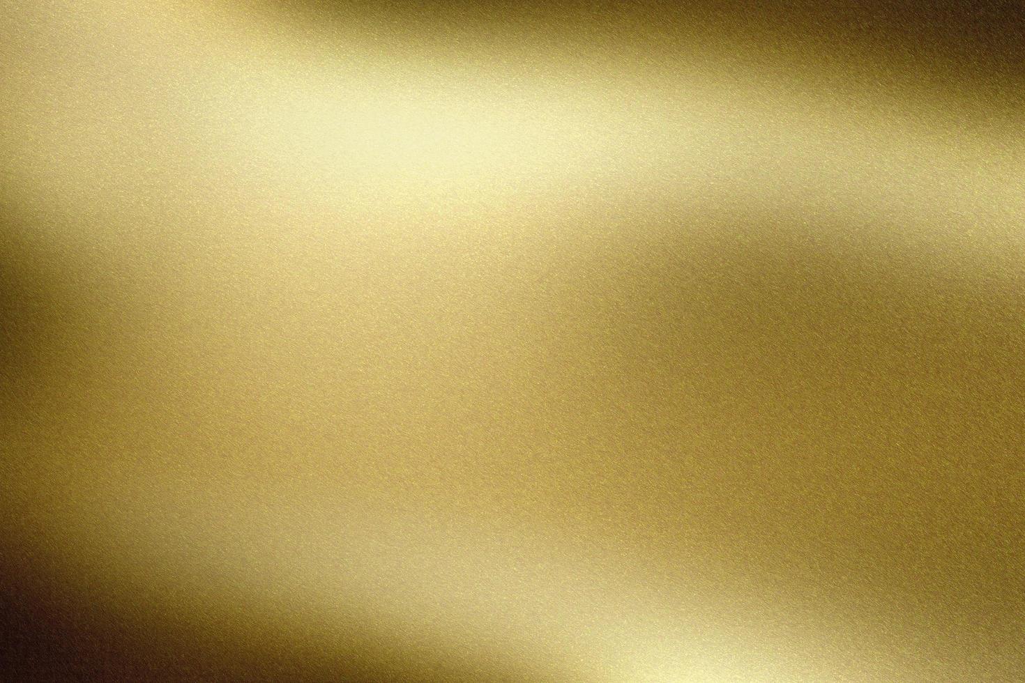 Brushed gold foil wave metallic wall, abstract texture background photo
