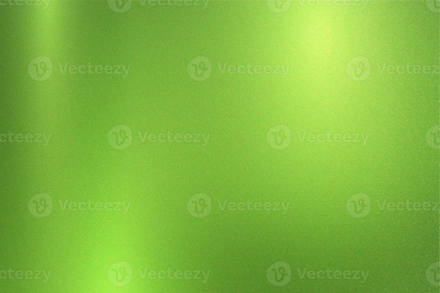 Green foil metallic wall with glowing shiny light, abstract texture background photo