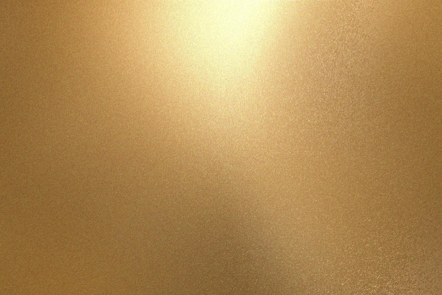 Light shining on rough gold metallic wall surfaces, abstract texture background photo