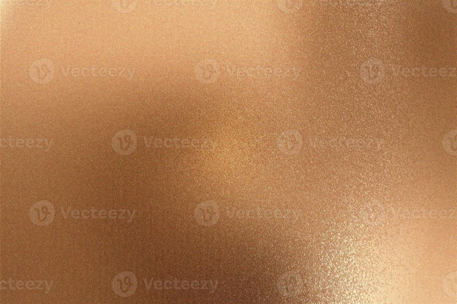 Glowing bronze metallic wall with scratched surface, abstract texture background photo