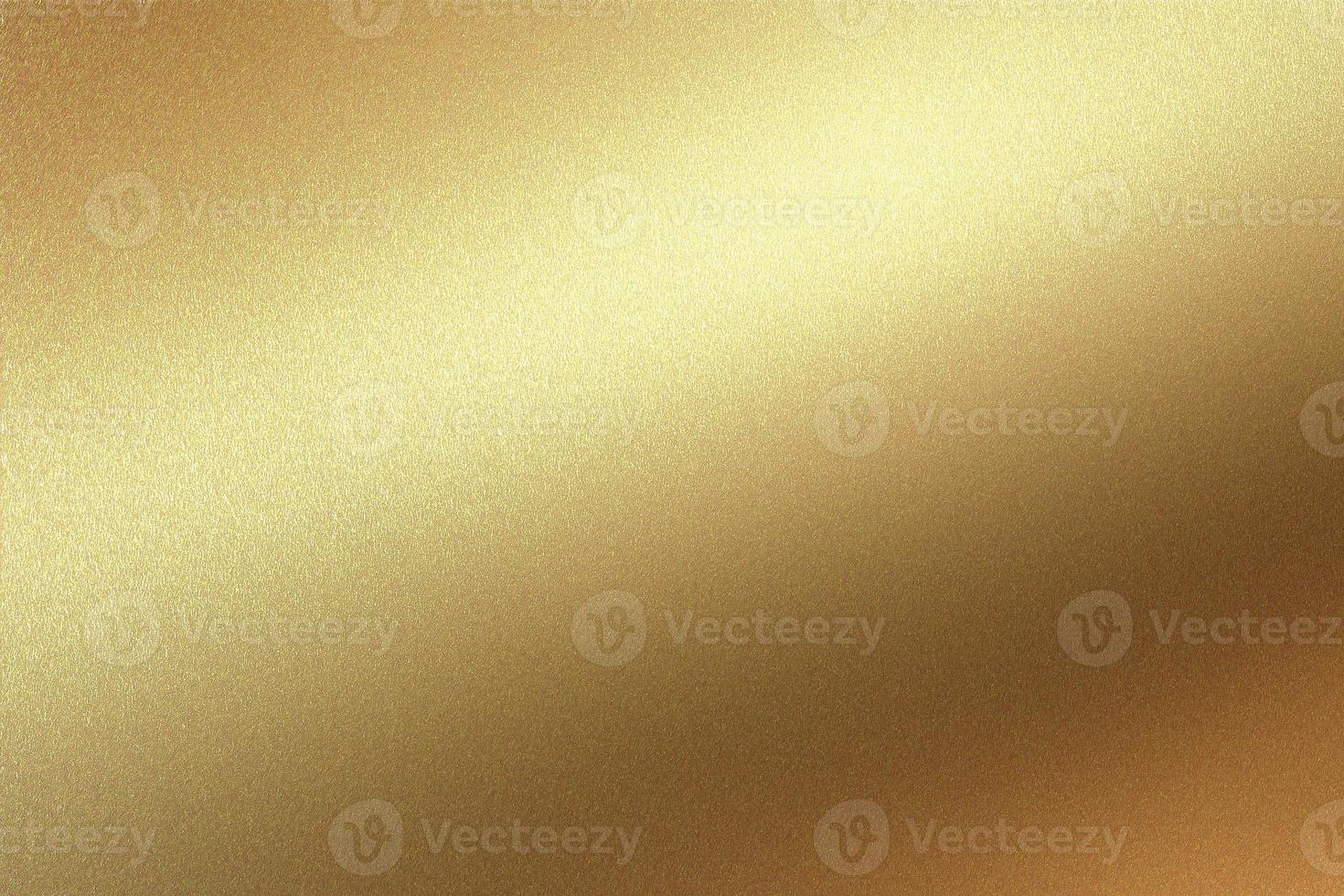 Glowing gold foil metal panel wall with copy space, abstract texture background photo