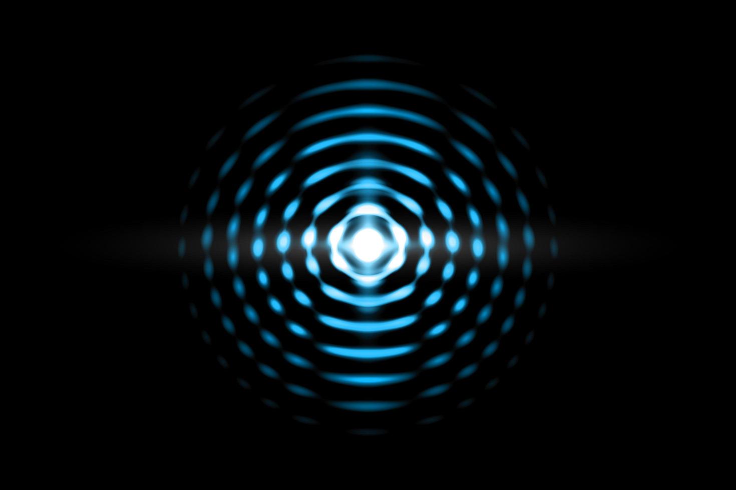 Abstract light blue ball effect with sound waves oscillating on black background photo