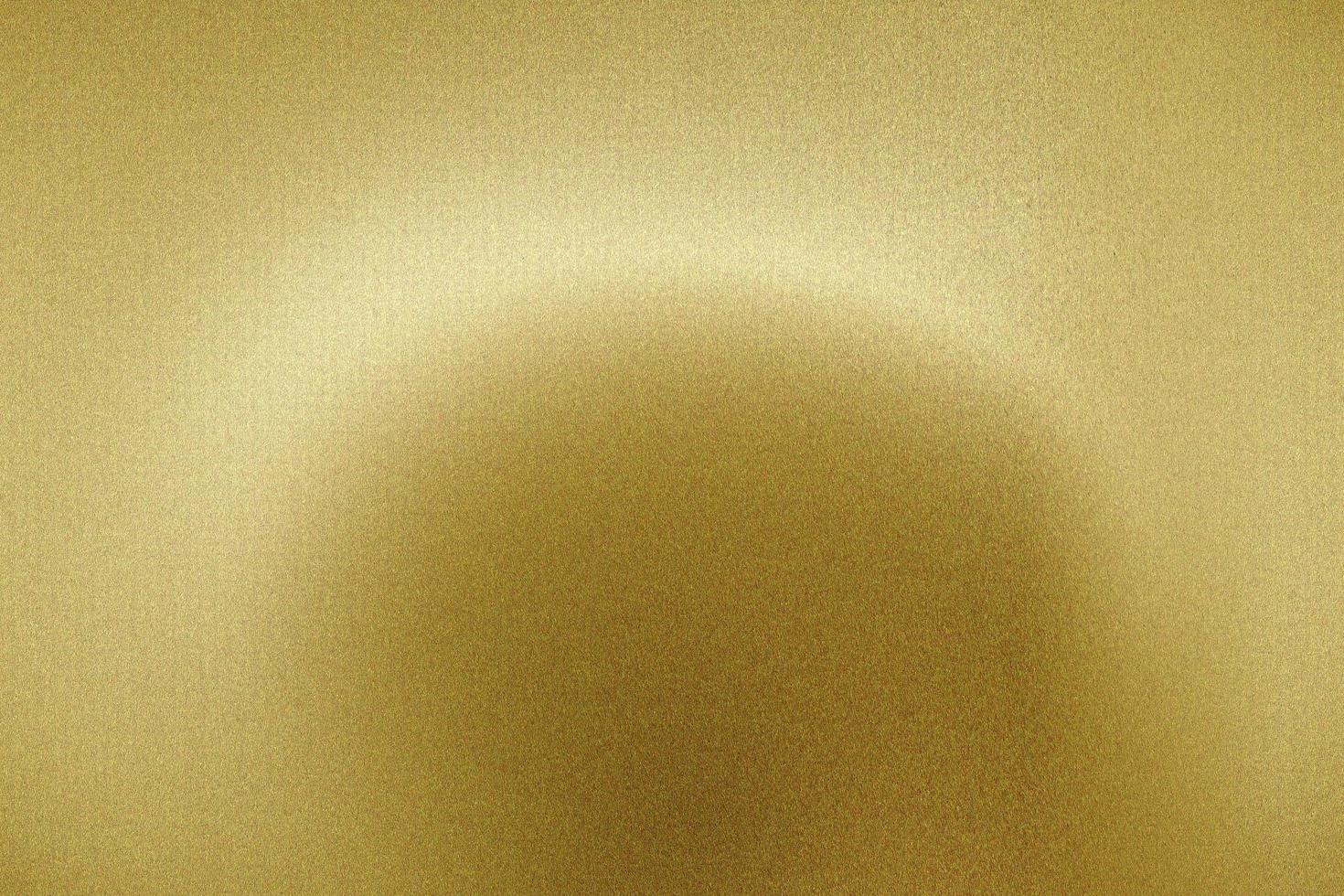 Light shining on brushed gold metal panel, abstract texture background photo