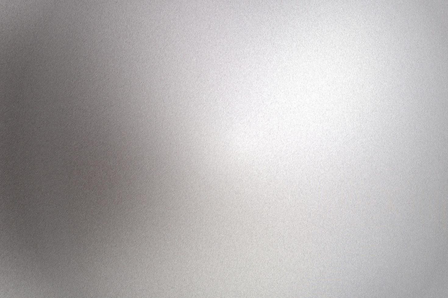 Light shining on gray silver foil glitter metallic wall with copy space, abstract texture background photo